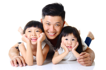 Asian father and his cute daughters  isolated on white backgroundの写真素材