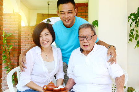 Portrait Of Chinese Asian Family Relaxing at outdoor home together.の写真素材