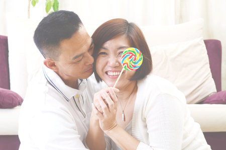 Happy Asian Middle age couple  in love having a good time at homeの写真素材