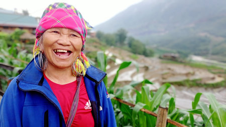 Sapa,Vietnam-May 14, 2023: Ethnic Hmong women smilling and wearing traditional attire and jewelry wait for tourists to sell handicrafts in Sapa region,Vietnam.のeditorial素材