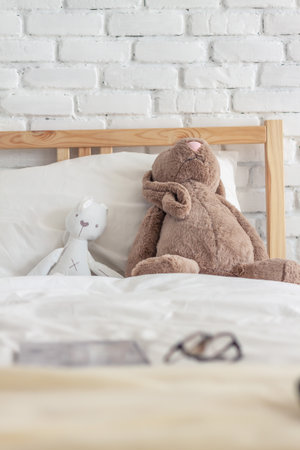 Kid's bedroom with dolls on the bed in the white toneの写真素材