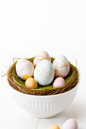 Easter eggs in a nest on a white wooden backgroundの素材