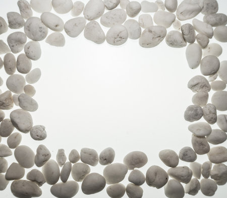 Many small white stones are arranged in white space.の写真素材