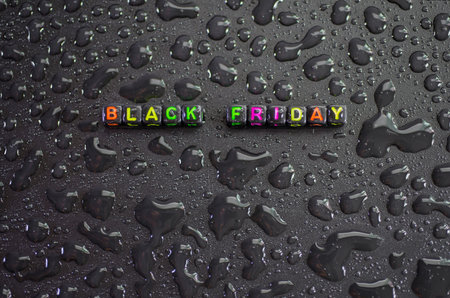 Black Friday, on the ground, liquid drops, abstract shapes on a black background.の写真素材