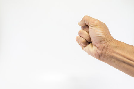 Human hand is an older male, rough skin and wrinkles. Show fisting on a white background with space.の写真素材