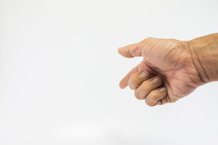 Human hands, old man, rough skin, and wrinkles show the index finger on a white background with empty space.の写真素材