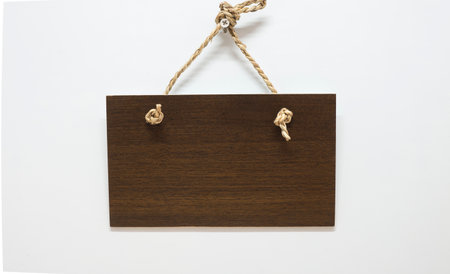 Hanging hangers made of oak wood have hanging ropes hanging on a white backdrop.の写真素材