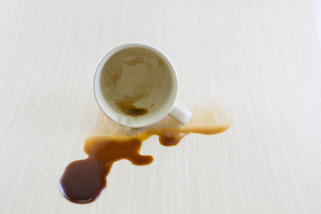 Spilled coffee cup stain on wooden floorの写真素材