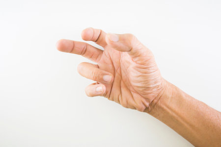 Finger of seniors who have problems trigger fingers on a white background.の写真素材