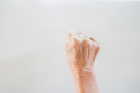 Hand and finger man is rough skin and wrinkles. Gesture on a white background with space.の写真素材
