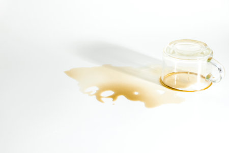 Drinks of coffee, spilled from a glass of sloppy on a white backgroundの写真素材