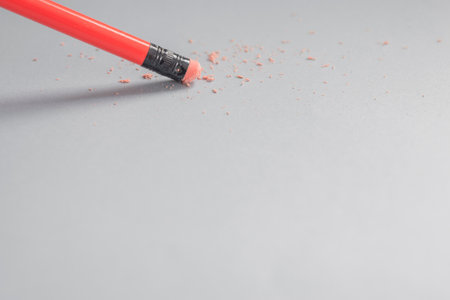 A pencil and eraser on a paper background with free spaceの写真素材