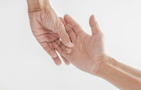 The hand image of the elderly with wrinkled skin Touching each otherの写真素材