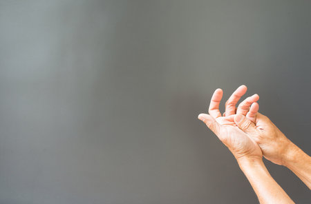Hands and bones, joints of the fingers that have problems on a gray background with free space