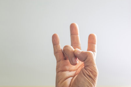 The hands and fingers of the elderly gestures shown on a white backgroundの写真素材