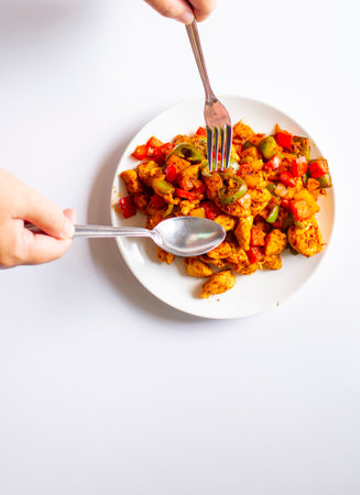 The hand of the one who was picking up the food rests on a white background.の写真素材