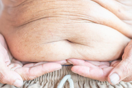 Hands holding their own belly The largeの写真素材