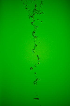abstract photo water drop surface on a green backgroundの写真素材