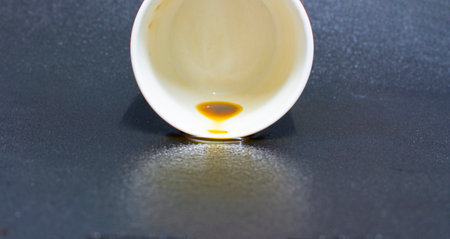 Coffee from the cup splashed on the floor.