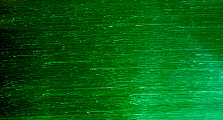 Blurred image of green light trail moving horizontally.の写真素材