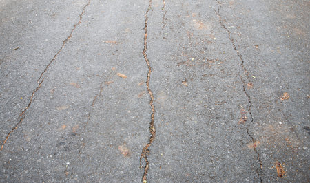 The cracks are damaged on the concrete road surface.の写真素材