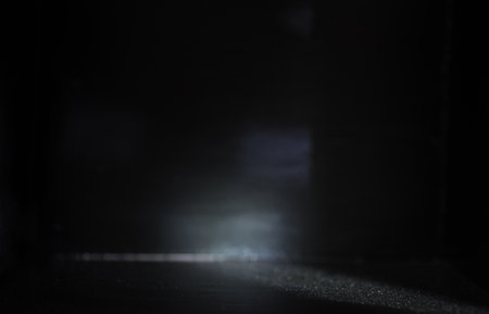 The backdrop of a black background with a beam of lightの写真素材