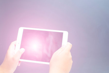 hand holding modern learning education equipment on gray backgroundの写真素材