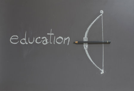 Pencil with bow on blackboard Educational conceptの写真素材