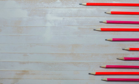 Many red pencils on a white wooden floor background and empty space.の写真素材