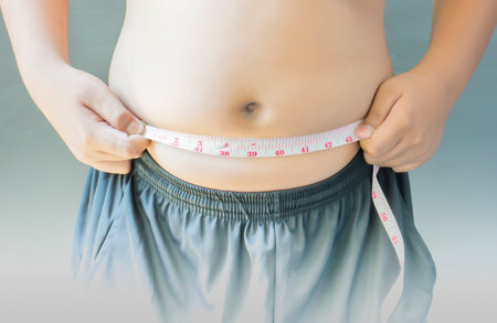 People with obesity are measuring their waist.の写真素材