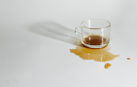The coffee from the glass is sloppy, on the white background.の写真素材