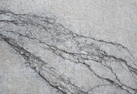 The concrete surface material is cracked.