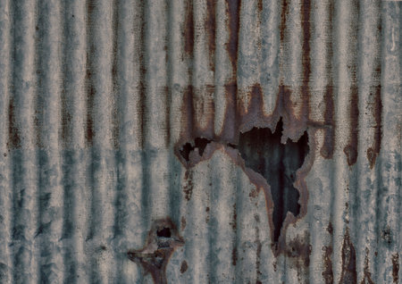 Metal wall panels that are old and rusting, weathering and damaged in holes.