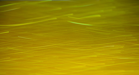 The background of a sparkling yellow light that moves in a lineの写真素材