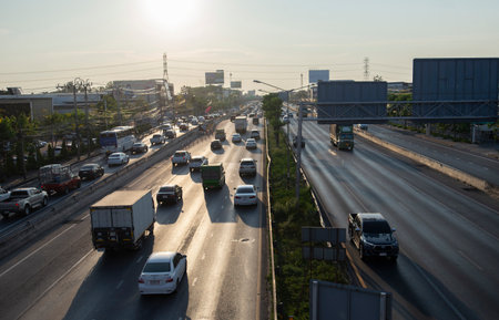 Many vehicles are driving on the road.