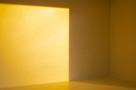 Light and shadow in the bright yellow roomの写真素材