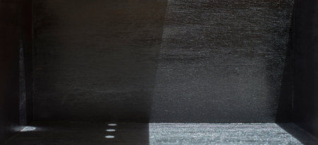 Light and shadow in a black room with empty space