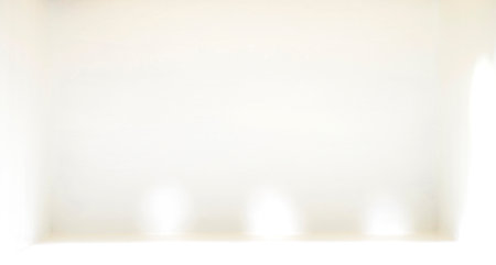 Image of spotlight and shadows falling in a white room with empty space