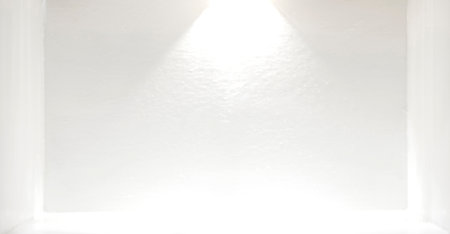 The image of spotlights and shadows inside the illuminated room in a white room.