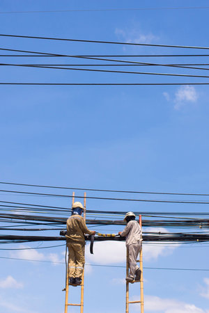 Technicians are working with electrical wires.