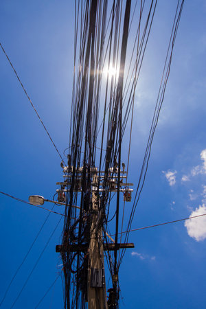 Installing electrical cable systems in cluttered outdoor locations disorganizedの写真素材