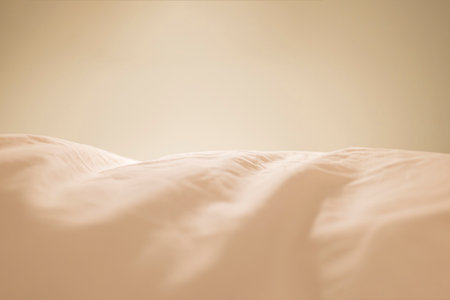 The surface of the cream-colored fabric has wrinkles.の写真素材