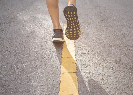 foot pose human leg person jogging Forward on the concrete road surface in outdoor places.の写真素材