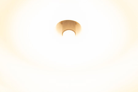The incandescent light glows in warm white tones.の写真素材