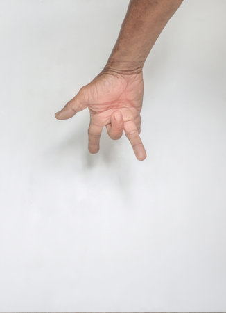 Concept image showing symptoms of hand muscles and fingers of an elderly person with wrinkled skin. rough on a white backgroundの写真素材