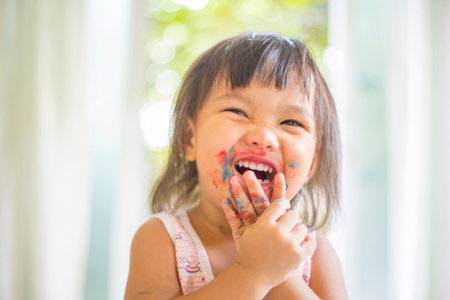A cheeky face and happy smile of an Asian girlの写真素材