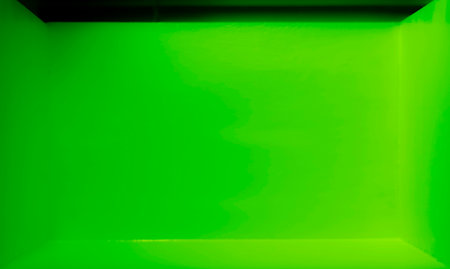 Space of light and shadow inside an empty dark green roomの写真素材