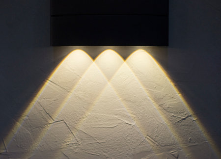 Decorative lighting decorates the walls and shadows the empty space for design work.