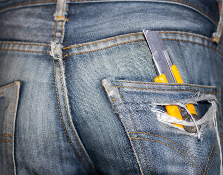 The man carried a knife cutter at the jeans pocket at the back.の写真素材