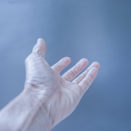 Finger gestures and wrinkled hands On a gray backgroundの写真素材